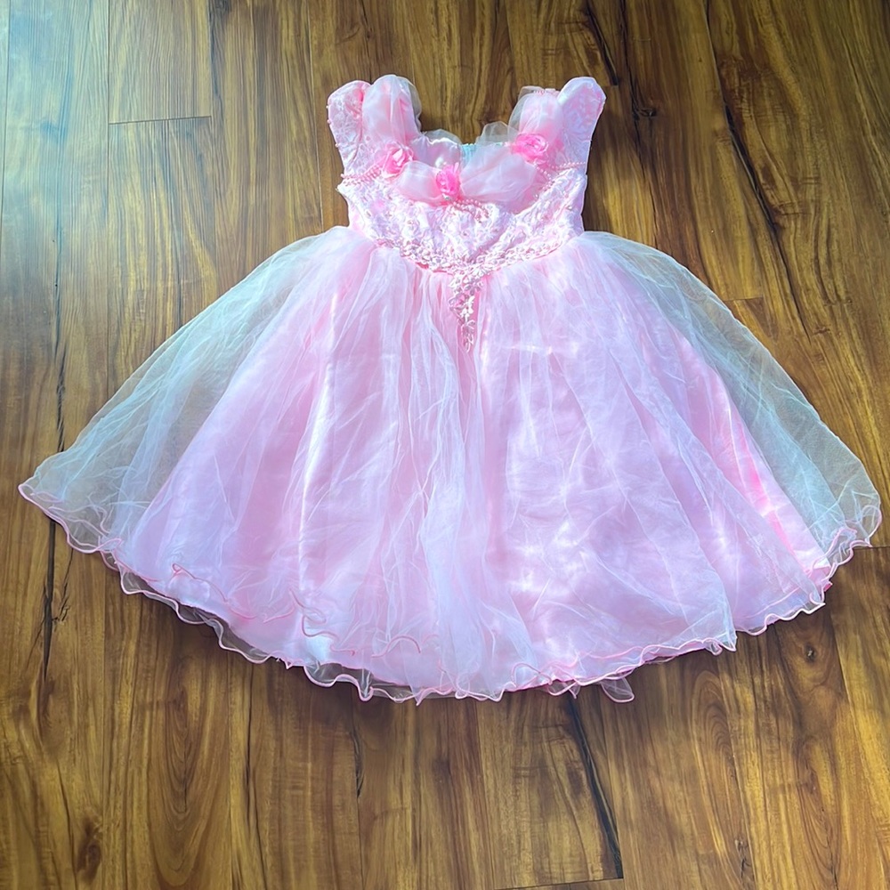 Cute wedding or party dress color pink with little flowers in front and a bow